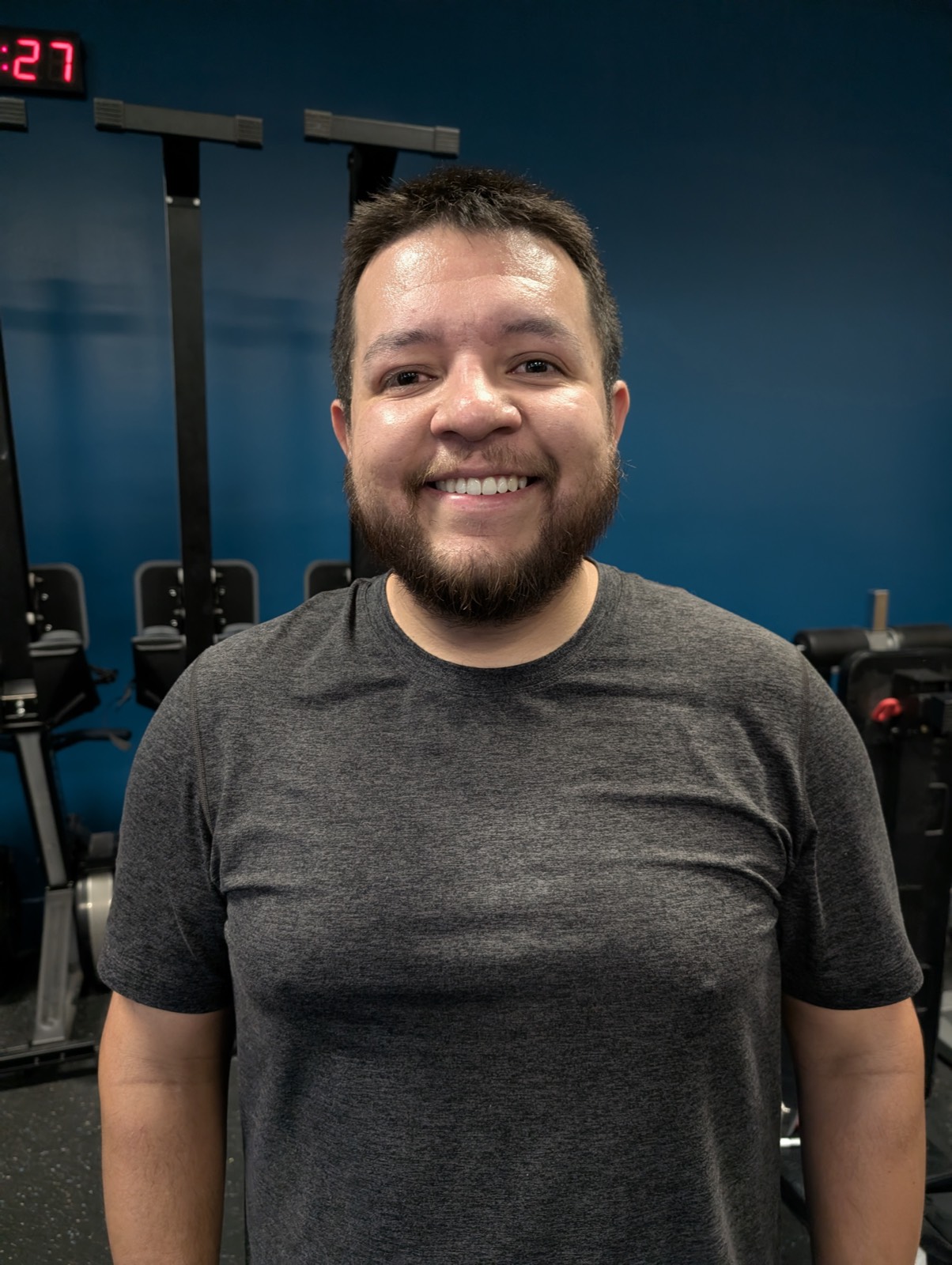 A Level Fitness member smiling in the gym