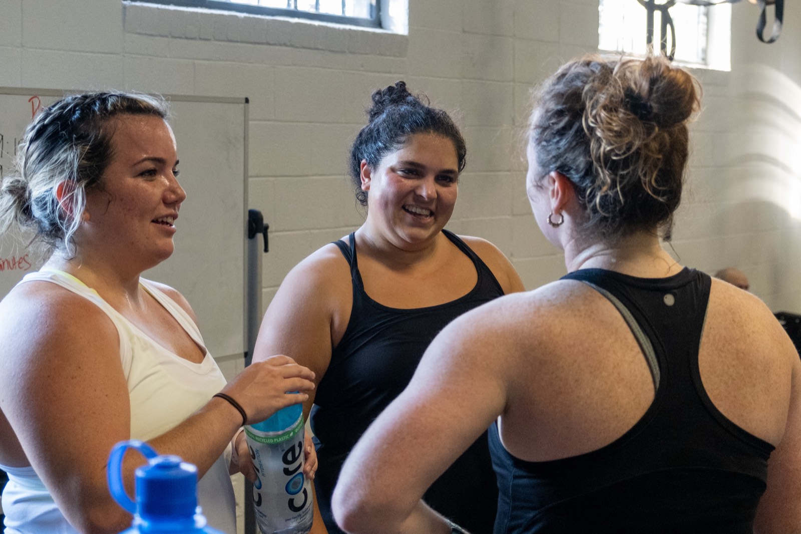 Three members laughing together after a class