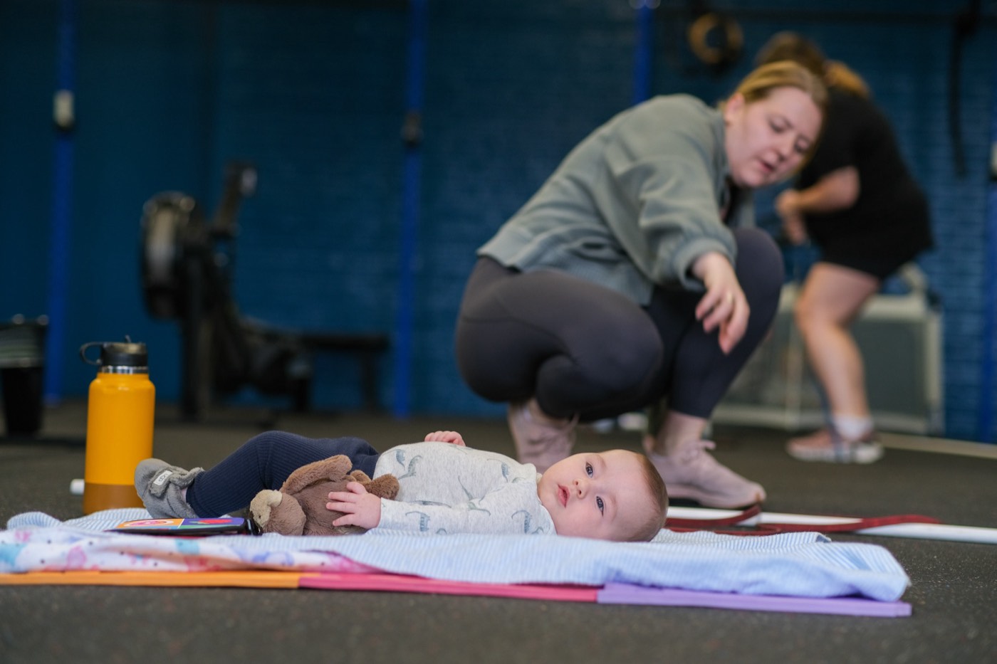 Babies settled on mats in the baby zone during class