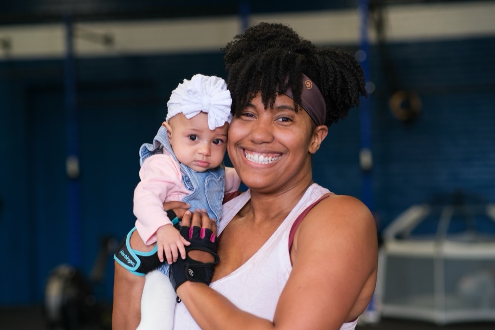 A MomFit member holding her baby