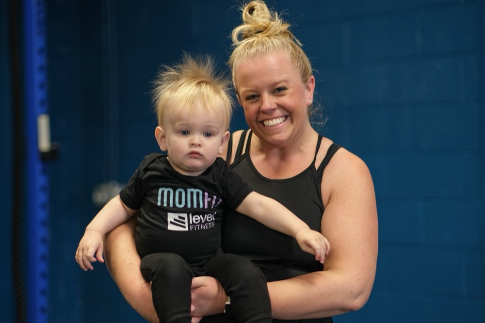 A MomFit member holding her baby