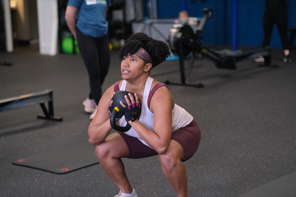 A mom at the bottom of a goblet squat